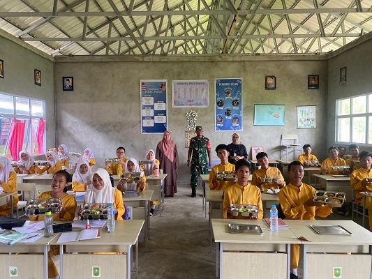 Babinsa Koramil 06 Kateman bersama tim SPPG mendistribusikan MBG ke sekolah (Fhoto dokumentasi Koramil 06 Kateman)